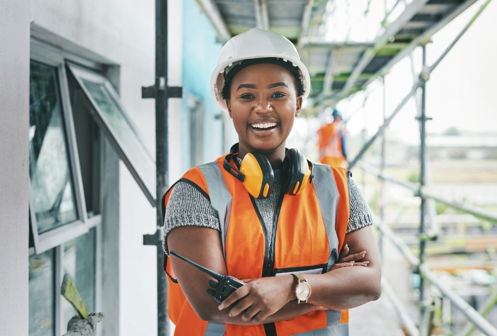 Portrait of a young woman working at a construction site